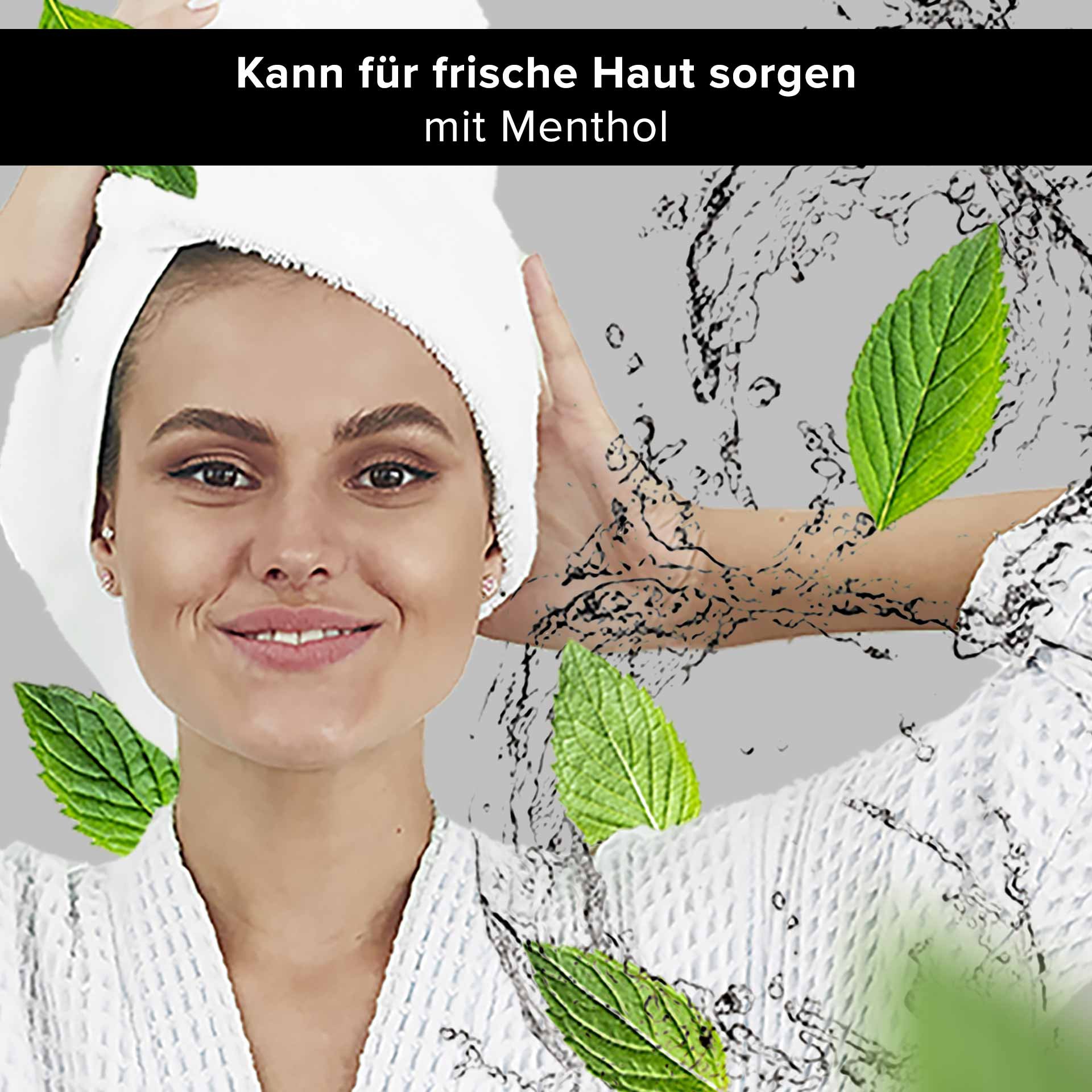 Woman with a towel on her head, smiling and surrounded by fresh mint leaves and water droplets, symbolizing refreshing skincare with menthol from RAU Cosmetics.
